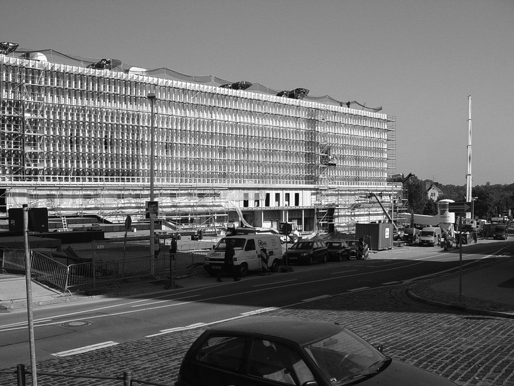 Blick entlang des Mehrzweckgebäudes von der Friedenstraße mit vorbereitenden Maßnahmen zur Anbringung der Fassadenverkleidung. Noch zu sehen ist die Lamellenfassade aus der DDR-Zeit, die unter Denkmalschutz gestellt wurde, Sommer 2005